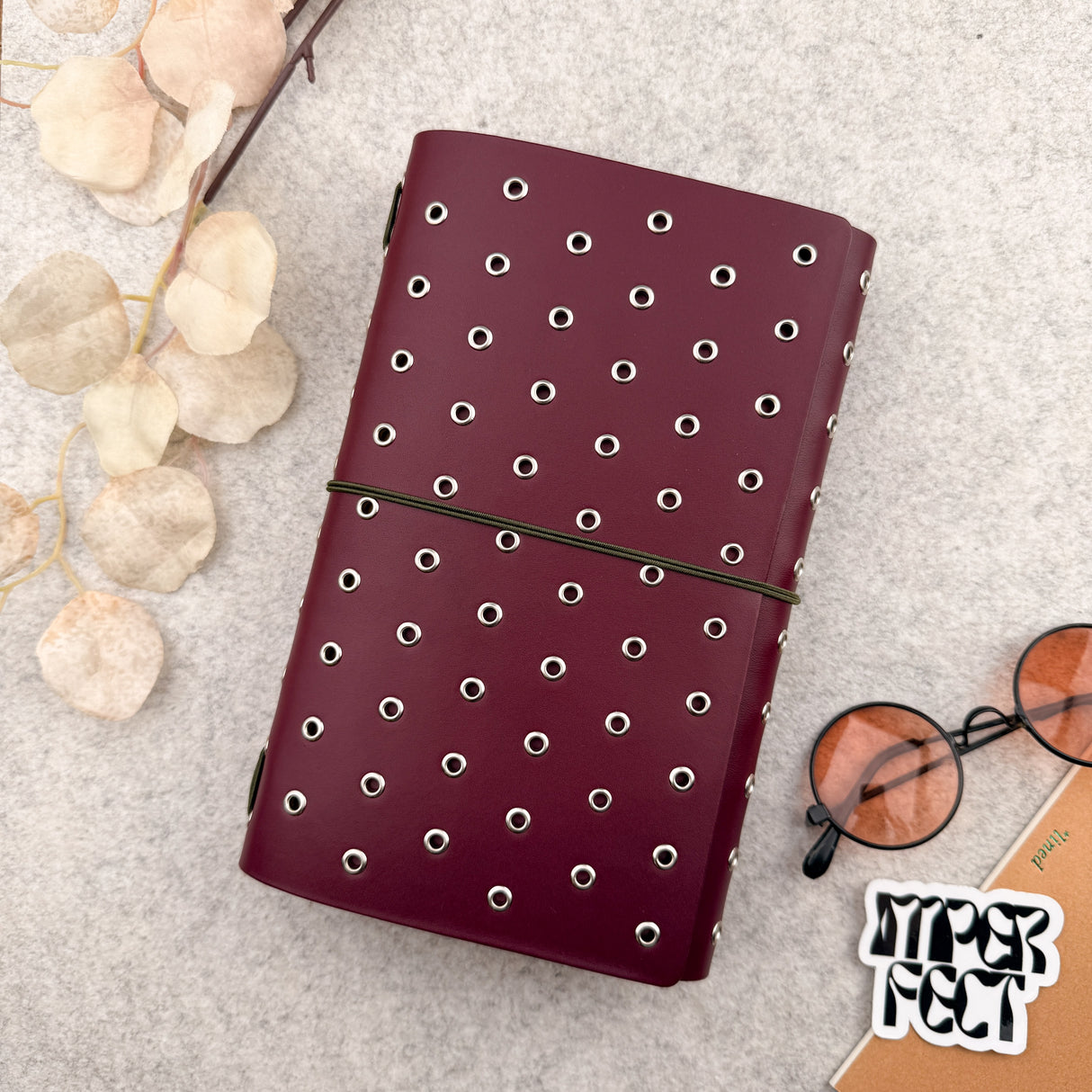 Imperfect Concepts Dancer Leather Notebook - A5 Trifold - Maroon w/ Silver Grommets
