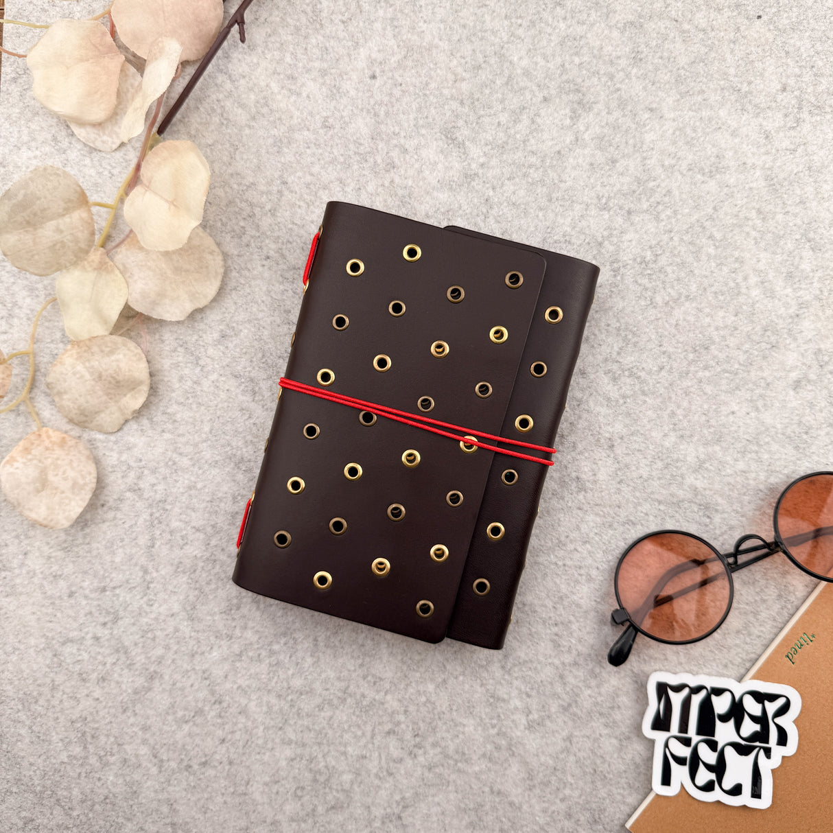 Imperfect Concepts Juniper Leather Notebook - A6 Trifold - Dark Brown w/ Gold & Brass Grommets