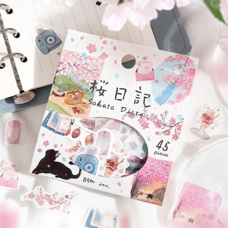 Packaging of Sakura Diary stickers with cherry blossoms and a cat illustration on a white surface.