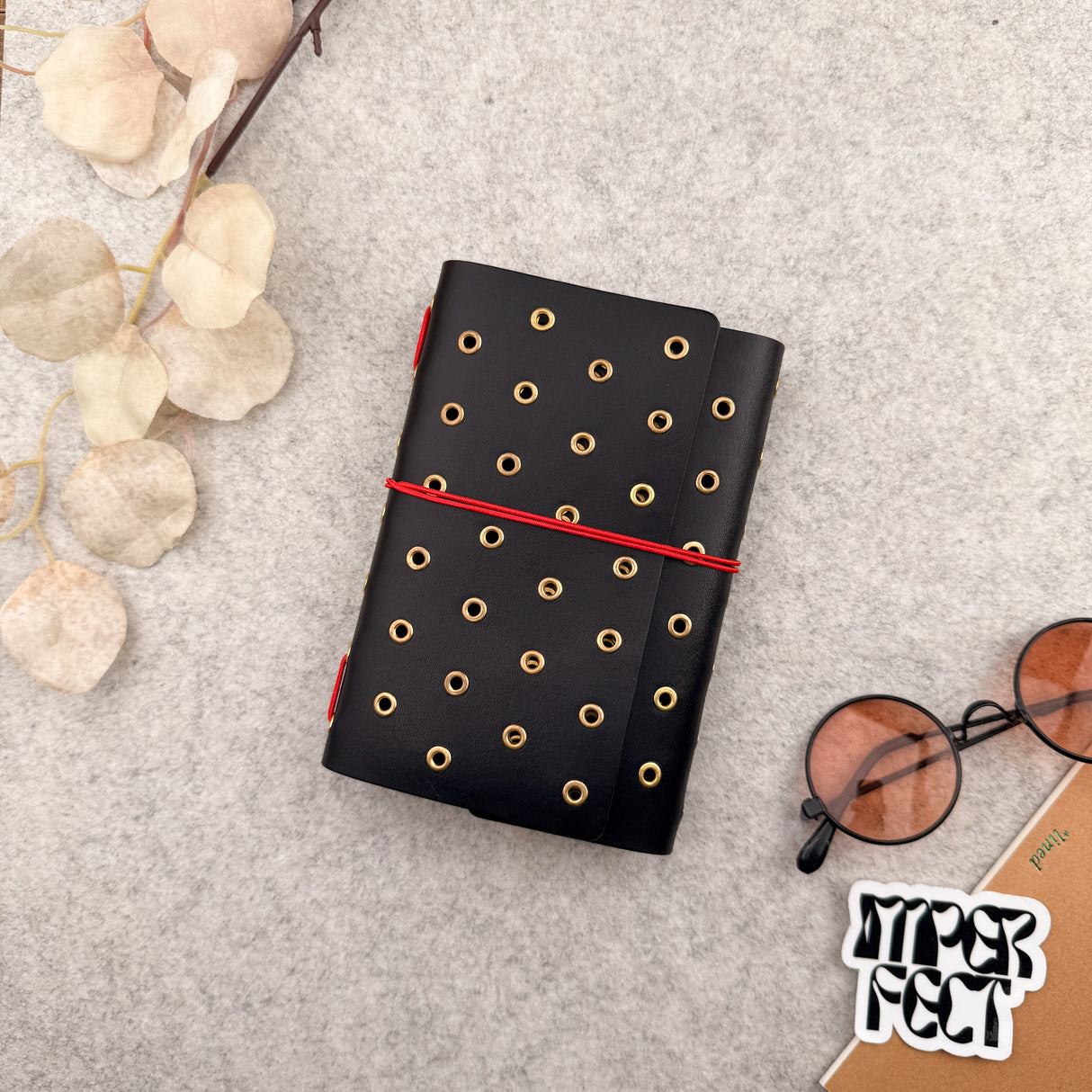 Imperfect Concepts Juniper Leather Notebook - A6  Trifold - Black w/ Gold Grommets